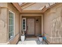 Cozy front porch featuring a security system, potted plants, and a well-lit entryway at 28814 N 45Th St, Cave Creek, AZ 85331