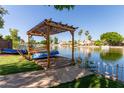 Beautiful community lake featuring a wooden pergola, boat access, and scenic views, enhancing the community's appeal at 3109 N Meadow Dr, Avondale, AZ 85392