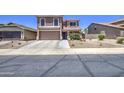 Attractive home with a two-car garage, desert landscaping, and covered entryway at 43822 W Baker Dr, Maricopa, AZ 85138