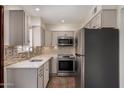 Updated kitchen featuring stainless steel appliances, light countertops, and a mosaic backsplash at 4630 N 68Th St # 264, Scottsdale, AZ 85251