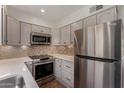 Stylish kitchen featuring stainless steel appliances, tiled backsplash, and bright countertop at 4630 N 68Th St # 264, Scottsdale, AZ 85251