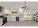Bright, remodeled kitchen featuring white cabinets, stainless appliances, and modern lighting fixtures at 4845 W Evans Dr, Glendale, AZ 85306