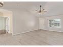 Open-concept living room featuring wood-look tile flooring, vaulted ceilings, and abundant natural light at 4845 W Evans Dr, Glendale, AZ 85306