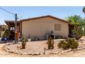 Side view of home exterior with desert landscaping featuring various cacti at 49478 W Val Vista Rd, Maricopa, AZ 85139