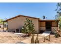 Home's side entrance with desert landscaping and concrete pathway at 49478 W Val Vista Rd, Maricopa, AZ 85139