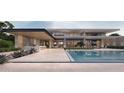 Inviting backyard featuring a modern pool, outdoor kitchen and lounge area, perfect for entertaining at 6525 E Bluebird Ln, Paradise Valley, AZ 85253