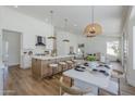 Modern kitchen with large island, pendant lighting, and stainless steel appliances at 7144 E Lakeview Ave, Mesa, AZ 85209