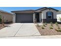Charming single-story home featuring a stone facade, neutral color palette, and low maintenance landscaping at 8577 W Trenton Ct, Florence, AZ 85132