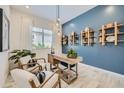 Stylish den with blue accent wall, modern desk, and comfortable seating area at 870 W Peralta Pass, Apache Junction, AZ 85120