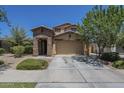Charming home features a stone accent entry, a two-car garage, and well-maintained landscaping at 9752 E Torino Ave, Mesa, AZ 85212