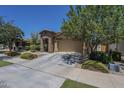 Charming home features a stone accent entry, a two-car garage, and well-maintained landscaping at 9752 E Torino Ave, Mesa, AZ 85212
