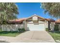 Charming home featuring a well-maintained lawn, mature trees, and a two-car garage, offering both curb appeal and practicality at 10023 E Sunnyslope Ln, Scottsdale, AZ 85258