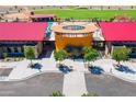 Aerial view of community clubhouse with pool, splash pad and seating areas at 12039 E Primrose Ln, Florence, AZ 85132