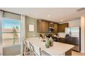 Bright kitchen features stainless steel appliances, breakfast bar, and a window with a view at 12039 E Primrose Ln, Florence, AZ 85132