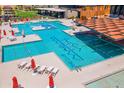 Stunning resort-style pool with lounge chairs and splash pad, perfect for relaxation and recreation at 12039 E Primrose Ln, Florence, AZ 85132