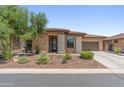 Well-maintained home showcasing a blend of stone and stucco exterior with a beautifully landscaped front yard at 13186 W Via Dona Rd, Peoria, AZ 85383