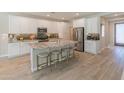 Modern kitchen with white cabinets, granite countertops, and stainless steel appliances at 13186 W Via Dona Rd, Peoria, AZ 85383