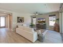 Cozy living room with wood floors, lots of light and stylish, neutral furnishings at 13186 W Via Dona Rd, Peoria, AZ 85383