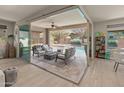 Indoor patio features a cozy seating area with a fire pit, overlooking a pool at 13186 W Via Dona Rd, Peoria, AZ 85383