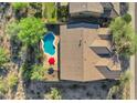 Aerial view of a private backyard pool with mountain views and tile roof at 13945 E Gail Rd, Scottsdale, AZ 85259
