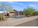 A pleasing single-story home showcasing a three-car garage and desert landscaping at 13945 E Gail Rd, Scottsdale, AZ 85259