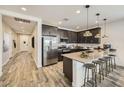 Modern kitchen features a large island with bar seating, stainless steel appliances, and sleek countertops at 1415 W J Waltz Way, Apache Junction, AZ 85120