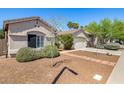 Attractive single-level home with well-kept landscaping and a convenient two-car garage at 14819 W Lupine Ln, Surprise, AZ 85374
