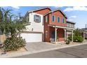 Charming two-story home showcasing a well-maintained lawn and an attached two-car garage at 15718 W Polk St, Goodyear, AZ 85338