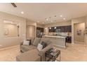 Open-concept living area with a view of the kitchen island and modern finishes, creating a seamless living space at 16417 W Piccadilly Rd, Goodyear, AZ 85395