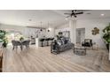 Bright, open-concept space featuring modern decor, a kitchen island, and stainless steel appliances at 16627 N Slate Ln, Maricopa, AZ 85139