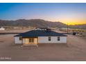 This home features a covered patio, an open backyard, and beautiful mountain views at 16627 N Slate Ln, Maricopa, AZ 85139