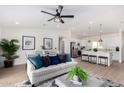 Bright, open-concept living space with a ceiling fan and modern decor at 16630 N Slate Ln, Maricopa, AZ 85139