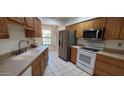 Well-equipped kitchen with modern appliances, wood cabinetry, and bright natural light at 17056 N 107Th Ave, Sun City, AZ 85373