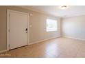 Bright living room with neutral walls, tile floors, and a window at 1811 W Roma Ave, Phoenix, AZ 85015