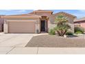 Charming single-story home featuring a desert landscape, neutral stucco, and a two-car garage at 1819 W Deer Creek Rd, Phoenix, AZ 85045