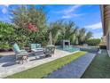 Inviting backyard with a sparkling pool, lush greenery, and comfortable seating area for outdoor relaxation at 2219 E Galileo Dr, Gilbert, AZ 85298