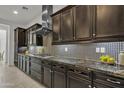 Gourmet kitchen with granite countertops, custom cabinetry, and professional-grade appliances at 2219 E Galileo Dr, Gilbert, AZ 85298