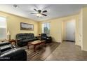 Cozy living room with tile and wood flooring and yellow walls providing warmth at 2993 E Meadowview Dr, Gilbert, AZ 85298