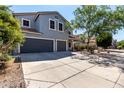 Two-story home with a three-car garage and landscaped front yard at 30165 W Flower St, Buckeye, AZ 85396