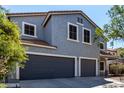 Close up on a two-story home with a three-car garage at 30165 W Flower St, Buckeye, AZ 85396