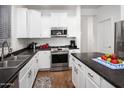 Modern kitchen with white cabinets, stainless steel appliances, and dark countertops at 4221 S Fireside Ct, Gilbert, AZ 85297