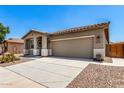 Charming single story home with a desert landscape and neutral color palette at 42519 W Centennial Ct, Maricopa, AZ 85138