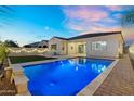 Backyard pool with clear blue water, well maintained landscaping, and hardscape at 4360 S Atom --, Mesa, AZ 85212