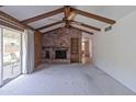 Inviting living room features exposed ceiling beams, a brick fireplace, and sliding glass doors to the backyard at 4515 N 35Th St, Phoenix, AZ 85018
