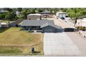 Expansive property with a single-story home featuring a spacious driveway and large storage buildings in the back at 4602 W Monte Cristo Ave, Glendale, AZ 85306