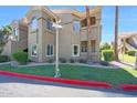 A three-story building with a stucco exterior, palm trees, and well-maintained landscaping at 5335 E Shea Blvd # 1087, Scottsdale, AZ 85254