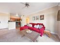 Cozy living room with a red sectional sofa and an open view to the kitchen with wood cabinets at 5335 E Shea Blvd # 1087, Scottsdale, AZ 85254