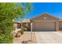 Charming single-story home with a two-car garage and a well-manicured front yard with desert landscaping at 5401 W Jessica Ln, Laveen, AZ 85339