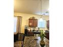 Traditional kitchen with stone countertops, stainless steel appliances, and tile flooring at 5616 W Hidalgo Ave, Laveen, AZ 85339