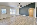 Bright, open living room with wood-look flooring, designer paint colors, and modern ceiling fan at 6419 W Monte Cristo Ave, Glendale, AZ 85306
